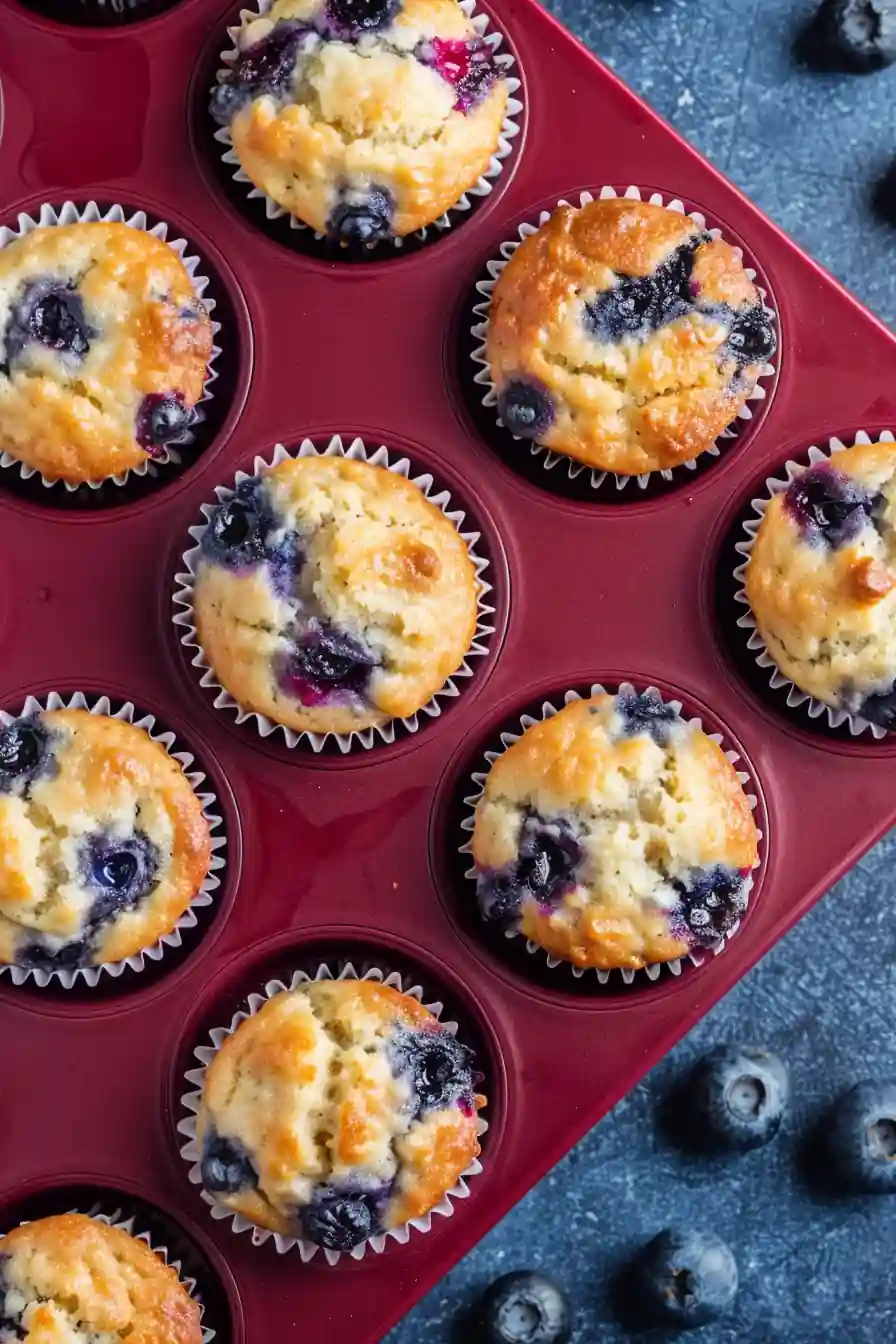 Lemon blueberry cottage cheese muffins with fresh lemon and blueberries